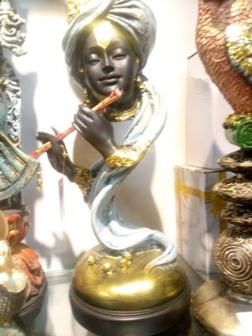 Black stone-finish Krishna idol playing the flute