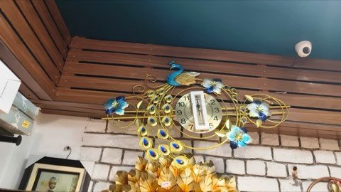 Peacock-design wall clock on display inside Jayanti Art Gallery, Kangra