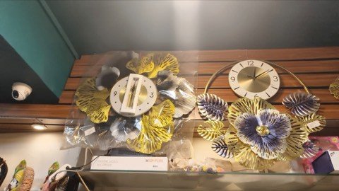 Wall clocks and floral metal wall decor on display in-store at Jayanti Art Gallery