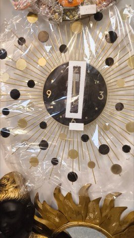 Modern sunburst-design wall clock in gold and black finish