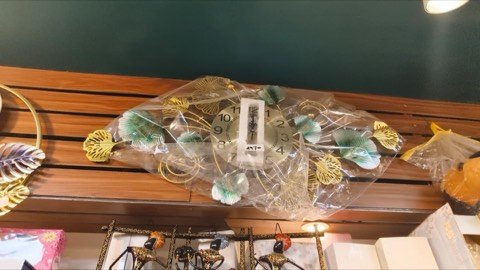 Decorative floral wall clock on display at Jayanti Art Gallery